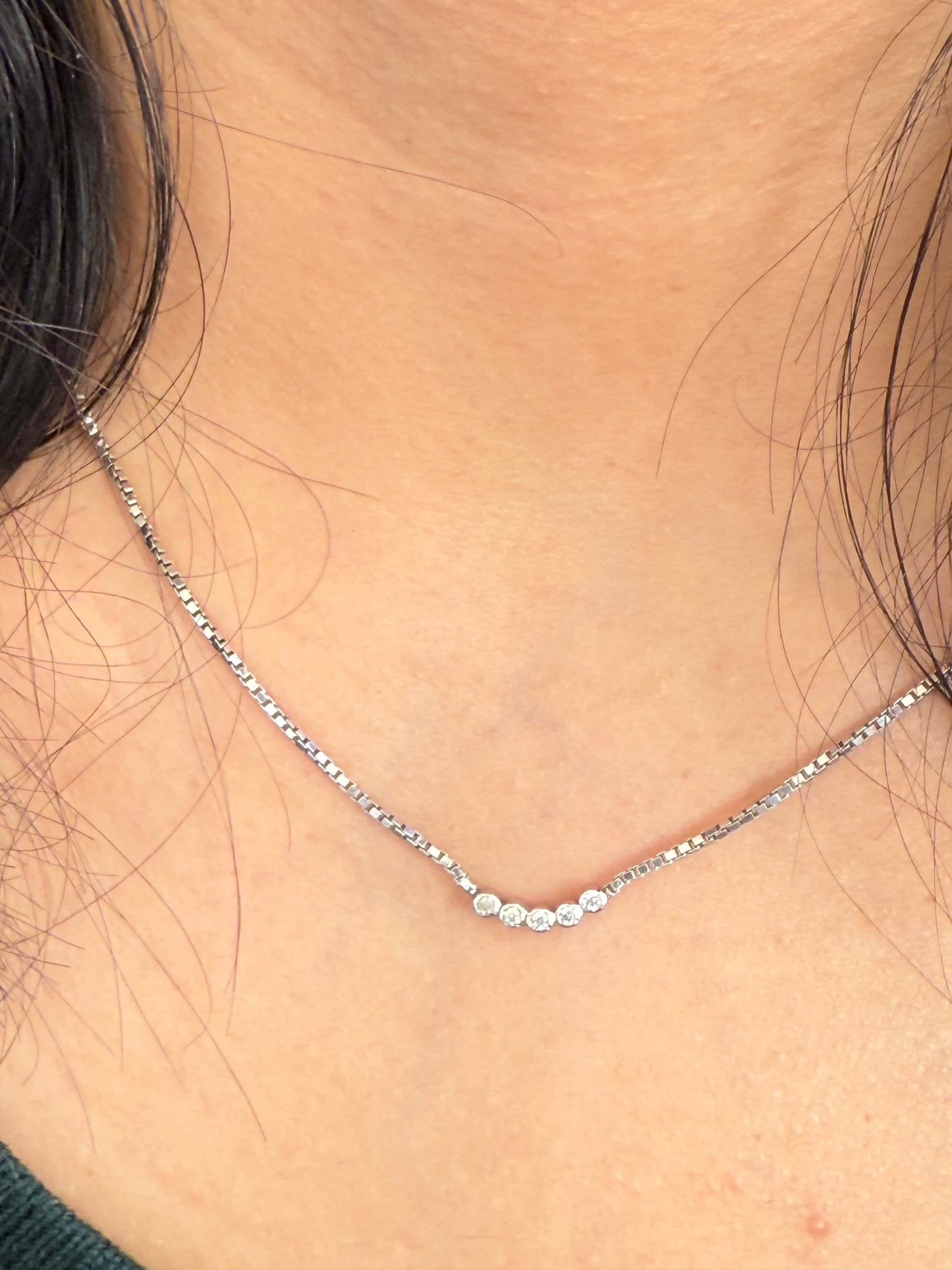 Five Dot Curved Pendant necklace on neck.