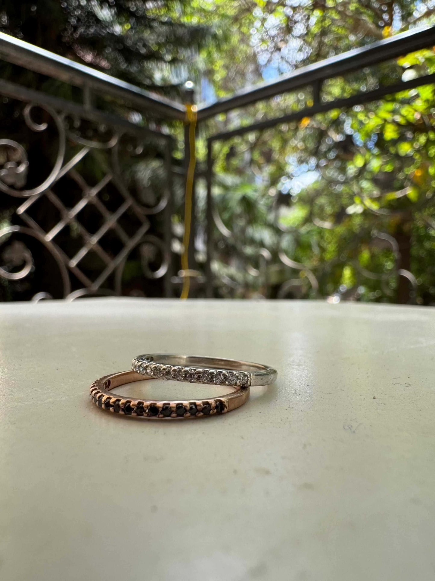 Thin Diamond Line Ring displayed outdoors with nature background.