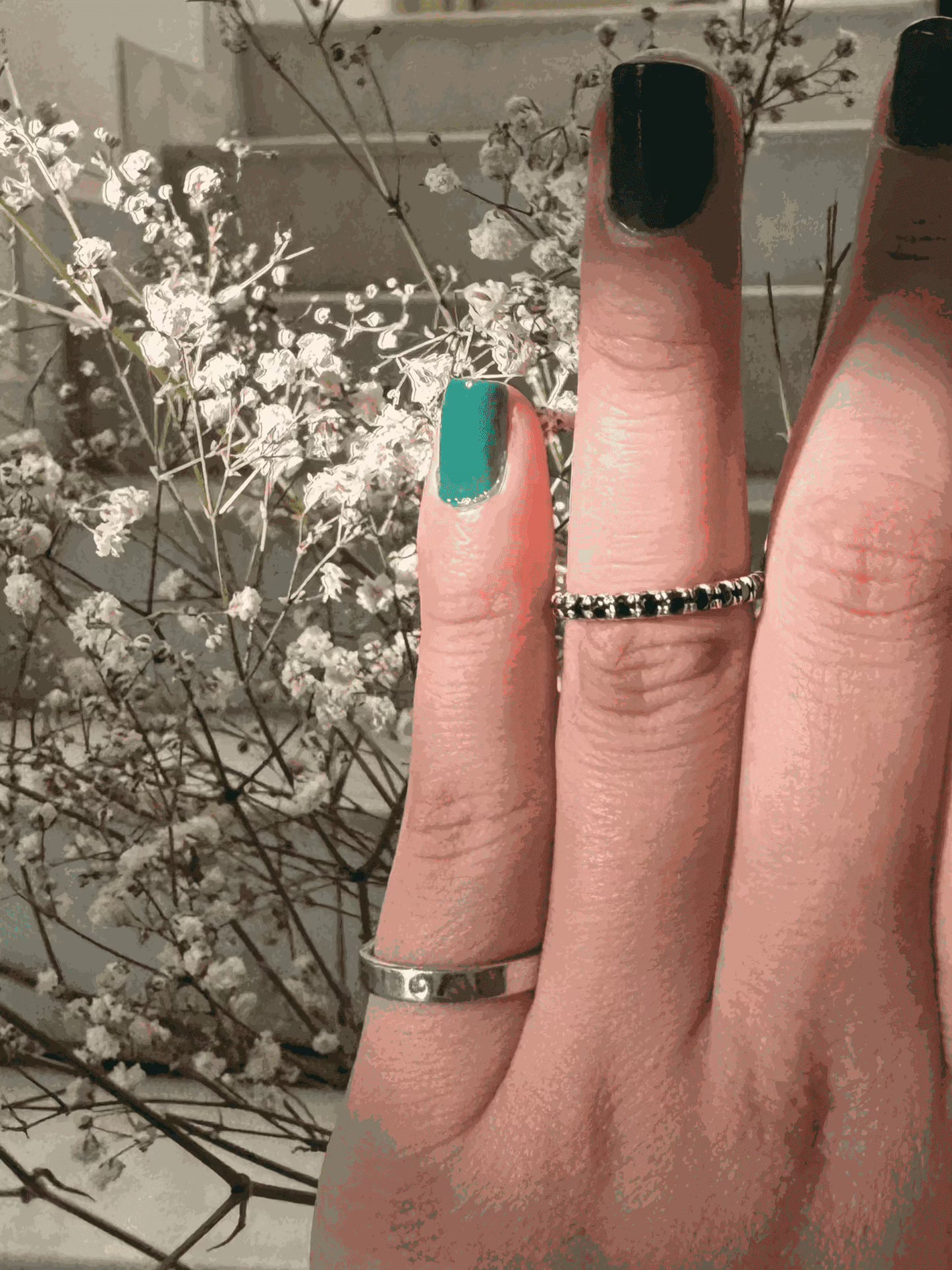 Thin Diamond Line Ring on Finger with Floral Background