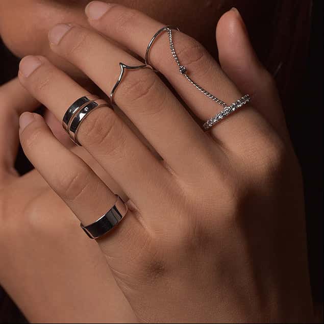Hand adorned with stylish dual rings.