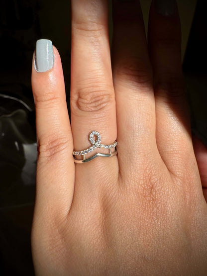 Crown ring with silver finish on finger.