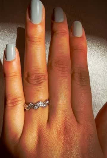 Marquese Ring on hand with polished nails.