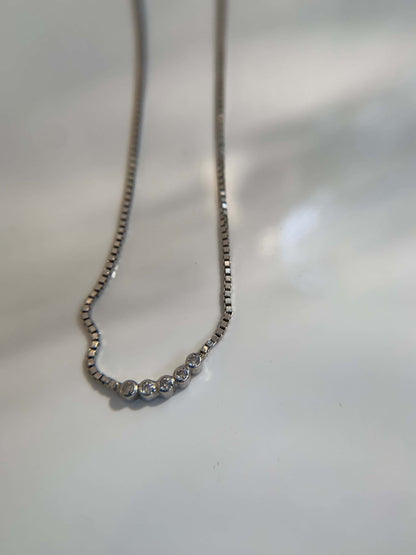 Elegant Five Dot Curved Pendant on a delicate chain.