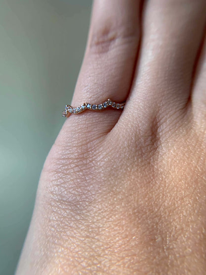 Elegant Three Peak Ring on finger with delicate design.