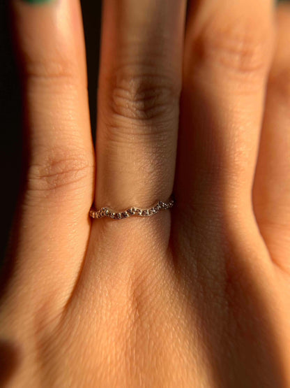 Three Peak Ring on a finger in soft lighting.