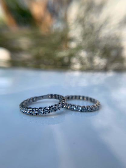 Two Classic Shine Line Rings with intricate detailing on a reflective surface.