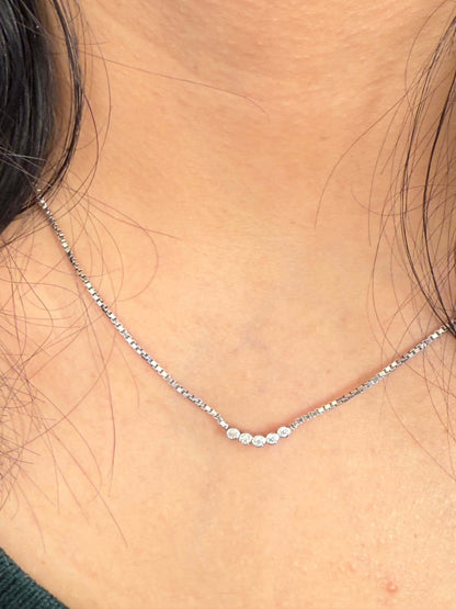 Five Dot Curved Pendant necklace on neck.