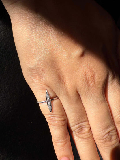 Hand wearing a Rice Ring with minimalist design.
