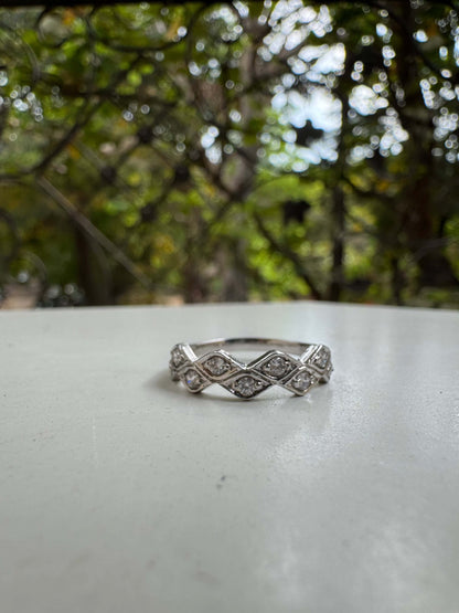 Marquese Ring with diamond accents against a natural backdrop.