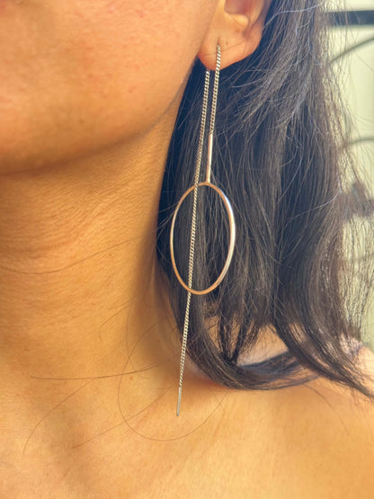 Woman wearing a circle thread earring.