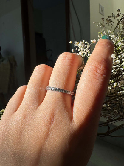 Classic Shine Line Ring on finger with delicate floral background.