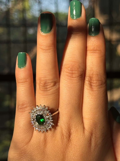 Green Cocktail Ring with emerald centerpiece on hand.